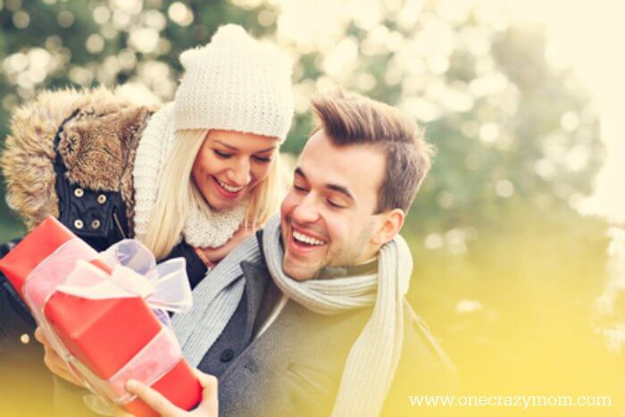 Find the best Electronic Gifts for Men. 20 gift ideas for men. Tech Gifts for men that won't break the bank.Gadgets for men they will love for Christmas. Man and women looking at a gift.