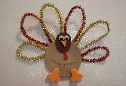 The kids will have a blast wiith these fun and easy Thanksgiving crafts for toddlers. 20 easy Thanksgiving crafts for toddlers they will love. Turkey magnet on fridge with pipe cleaner feathers.