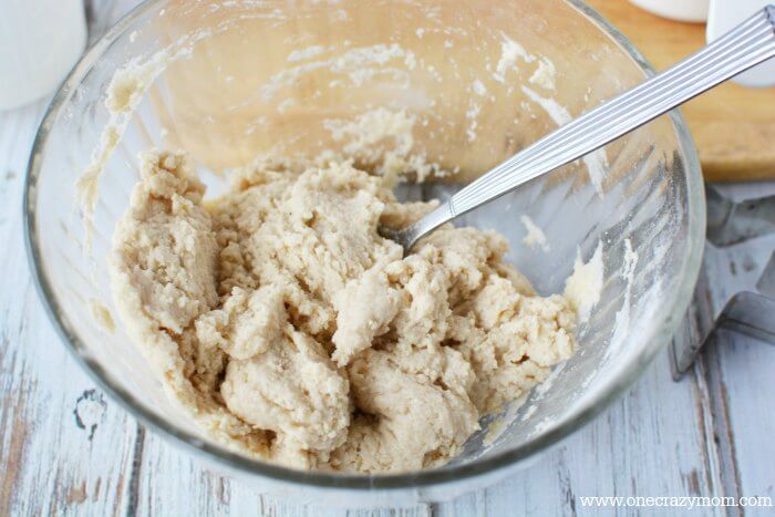 Make special memories with this simple and fun Salt Dough Ornament Recipe for Christmas. Learn how to make salt dough ornaments so easy the entire family can help! This great ornament DIY is perfect for kids. #onecrazymom #christmasornaments #DIYornaments #saltdoughornaments Ingredients being mixed in a bowl.