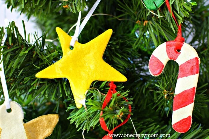 Make special memories with this simple and fun Salt Dough Ornament Recipe for Christmas. Learn how to make salt dough ornaments so easy the entire family can help! This great ornament DIY is perfect for kids. #onecrazymom #christmasornaments #DIYornaments #saltdoughornaments Salt dough ornaments on a tree.