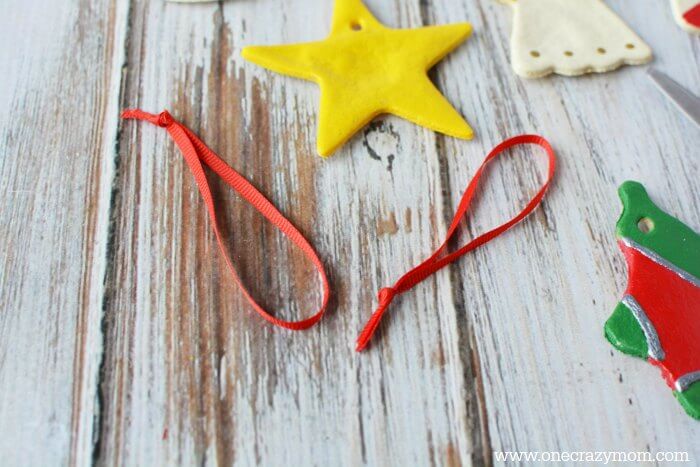 Make special memories with this simple and fun Salt Dough Ornament Recipe for Christmas. Learn how to make salt dough ornaments so easy the entire family can help! This great ornament DIY is perfect for kids. #onecrazymom #christmasornaments #DIYornaments #saltdoughornaments String ready for ornaments.