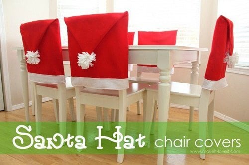 Create Christmas table top decorations with these easy ideas. 15 DIY Christmas table decorations anyone can make. Simple Christmas table decoration ideas. Santa Hat chair covers on a white table.