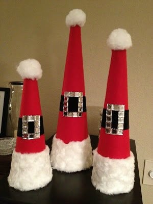 Create Christmas table top decorations with these easy ideas. 15 DIY Christmas table decorations anyone can make. Simple Christmas table decoration ideas. Santa hats grouped together.