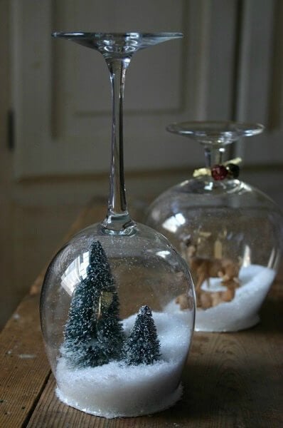 Create Christmas table top decorations with these easy ideas. 15 DIY Christmas table decorations anyone can make. Simple Christmas table decoration ideas. Stemware turned into snow globes.