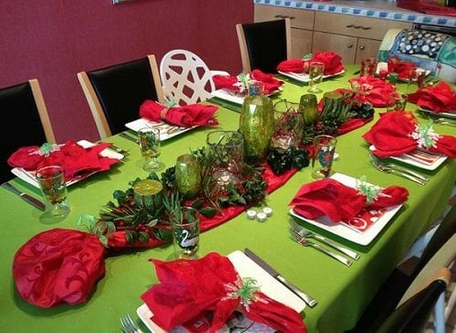 Create Christmas table top decorations with these easy ideas. 15 DIY Christmas table decorations anyone can make. Simple Christmas table decoration ideas. Red and Green table setting with greenery and candles.