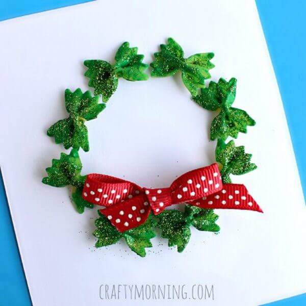Find Easy Christmas ideas for families here. 20 Fun Christmas activities ideas for kids or toddlers from crafts to games that kids will love. Christmas activities to keep them busy. These are perfect for the classroom too! #onecrazymom #christmasactivities #kidactivities Christmas wreath made out of pasta on paper.