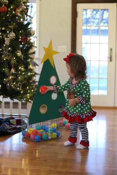 Find Easy Christmas ideas for families here. 20 Fun Christmas activities ideas for kids or toddlers from crafts to games that kids will love. Christmas activities to keep them busy. These are perfect for the classroom too! #onecrazymom #christmasactivities #kidactivities Christmas tree ball sorting activity.