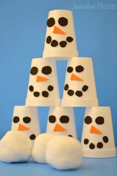 Find Easy Christmas ideas for families here. 20 Fun Christmas activities ideas for kids or toddlers from crafts to games that kids will love. Christmas activities to keep them busy. These are perfect for the classroom too! #onecrazymom #christmasactivities #kidactivities Snowman bowling game with cups.