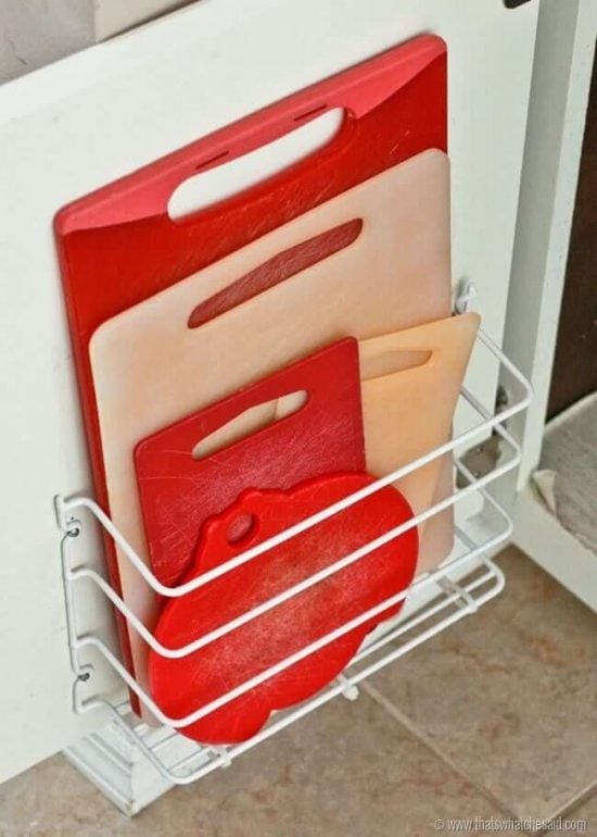 Get your home in order with Dollar Store Home Organization Ideas. 20 creative ways to make the most of your space with Dollar Store home organization. Cutting Boards stored on cabinet.
