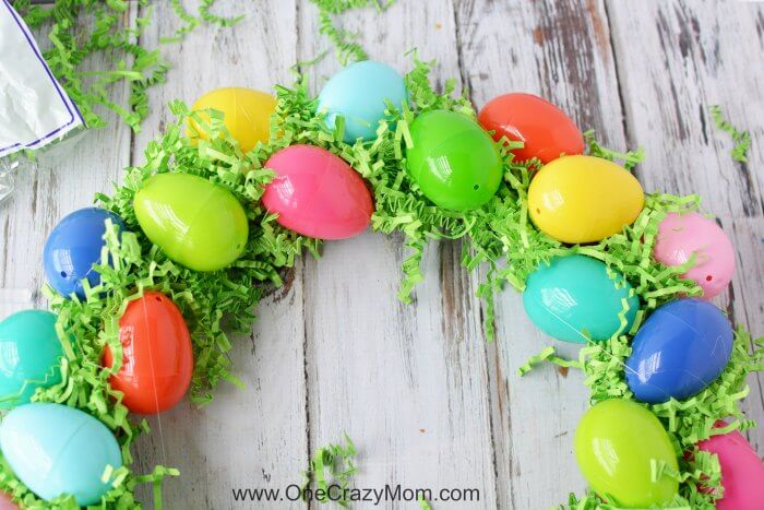 Make this DIY Easter Egg Wreath with items from the dollar store. You will love this easy Easter Egg Wreath DIY. Try this frugal Easter craft today. Filler in between eggs.