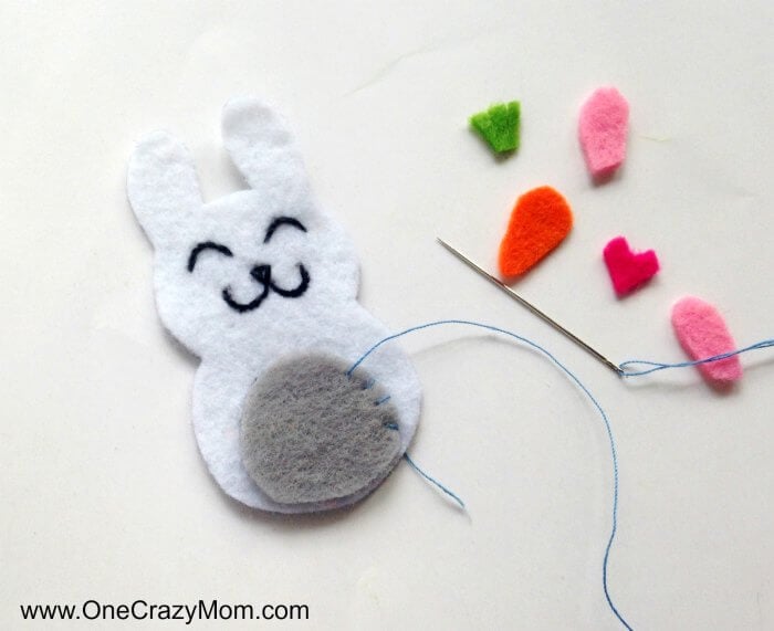Easter felt crafts are so fun! Learn how to make a Bunny Charm. DIY Easter crafts are so simple. Kids will love this easy bunny craft! Find Easter craft ideas for kids. Easter crafts for kids they will love! Bunny craft with felt being sewn.