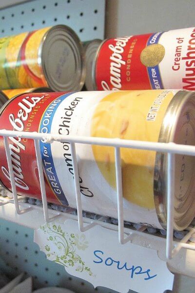You will love these Dollar Store Kitchen Organization ideas! 20 Kitchen Organization hacks to get your kitchen in order for just a $1! You can't beat that! Cans of soup in a wire organizer.