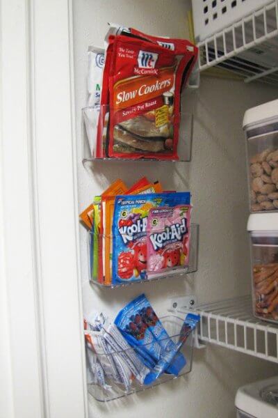 You will love these Dollar Store Kitchen Organization ideas! 20 Kitchen Organization hacks to get your kitchen in order for just a $1! You can't beat that! Bins attached to alls for packets.
