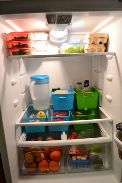 You will love these Dollar Store Kitchen Organization ideas! 20 Kitchen Organization hacks to get your kitchen in order for just a $1! You can't beat that! Bins in the fridge with items.