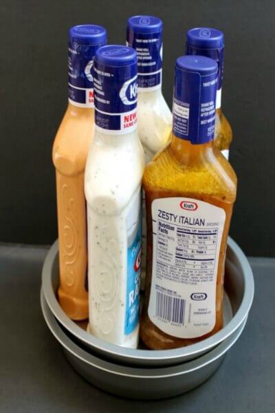 You will love these Dollar Store Kitchen Organization ideas! 20 Kitchen Organization hacks to get your kitchen in order for just a $1! You can't beat that! Lazy Susan with dressings.