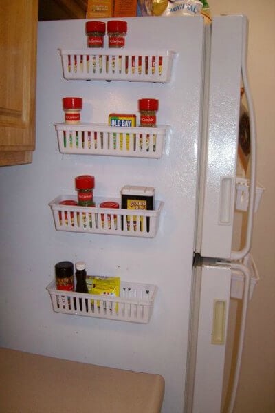 You will love these Dollar Store Kitchen Organization ideas! 20 Kitchen Organization hacks to get your kitchen in order for just a $1! You can't beat that! Spices in racks on the side of the fridge.