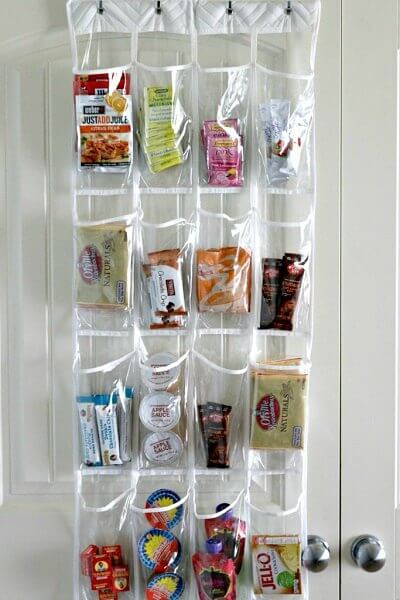 You will love these Dollar Store Kitchen Organization ideas! 20 Kitchen Organization hacks to get your kitchen in order for just a $1! You can't beat that! Hanging shoe organizer with snacks.