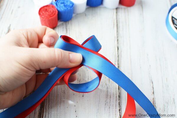 This DIY 4th of July wreath is made with crepe paper and takes very little time to make! Try this Fourth of July wreath with dollar store supplies! This DIY 4th of July wreath is made with crepe paper and takes very little time to make! Try this Fourth of July wreath with dollar store supplies!
