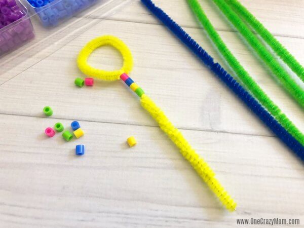 Learn how to make a bubble wand. Make this diy bubble wand for tons of fun. Homemade bubble wands are easy to make. Kids will love decorating the wands with beads. Bubble Wands with beads going on.