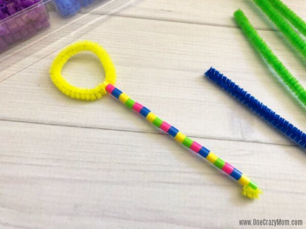 Learn how to make a bubble wand. Make this diy bubble wand for tons of fun. Homemade bubble wands are easy to make. Kids will love decorating the wands with beads. Wand with beads on the handle.