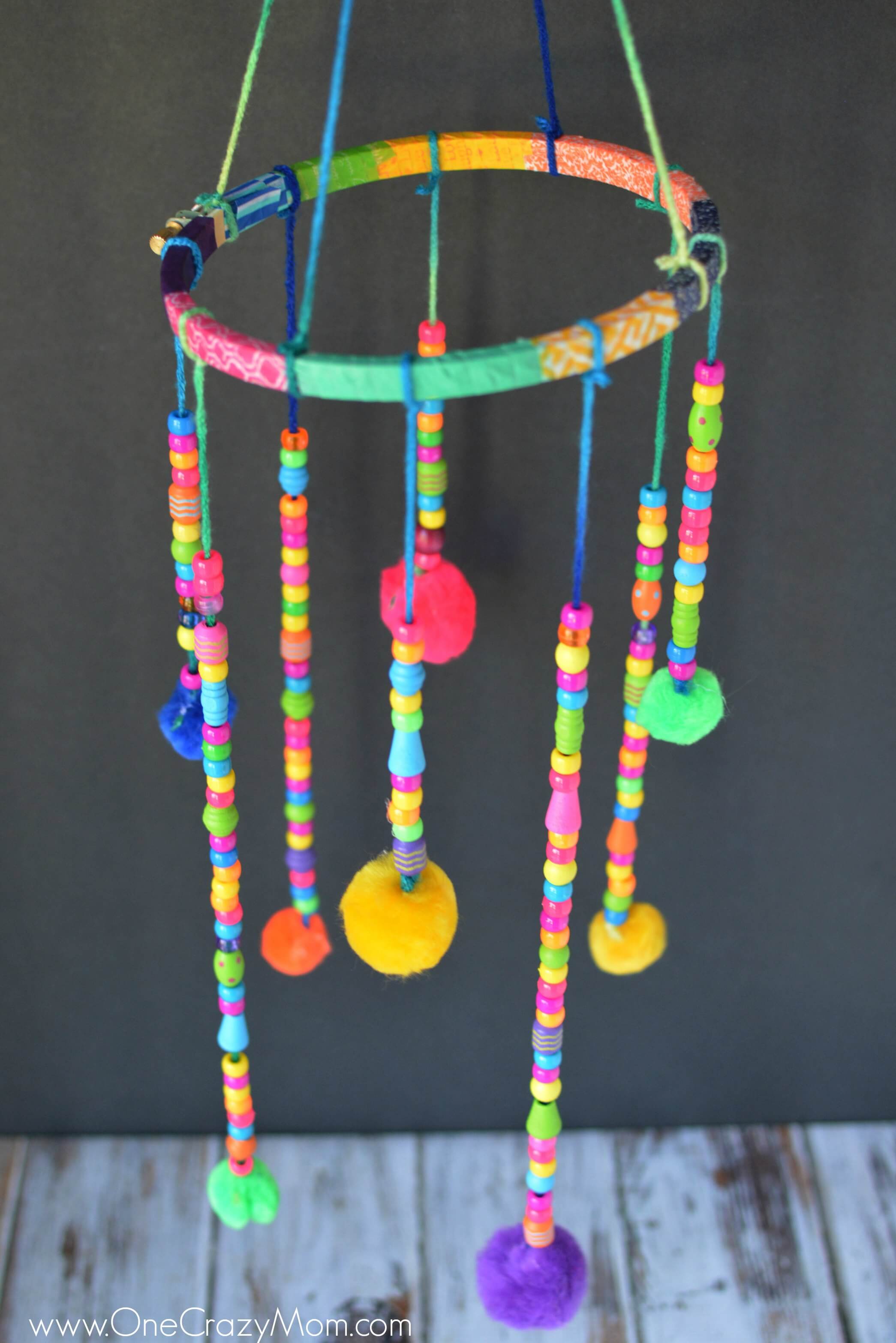 DIY wind chimes are really simple to make. Learn how to make wind chimes. It's so simple and easy. Everyone will have a blast making these pretty wind chimes. DIY Wind Chimes hanging.