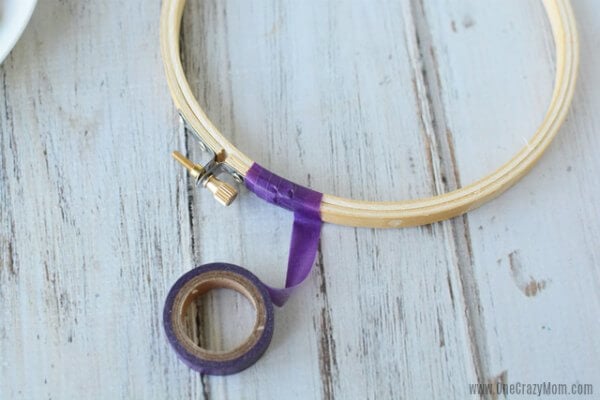 DIY wind chimes are really simple to make. Learn how to make wind chimes. It's so simple and easy. Everyone will have a blast making these pretty wind chimes. Hoop with washi being wrapped around.