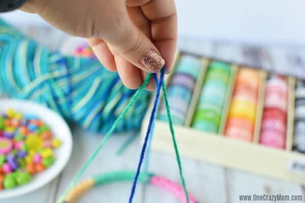 DIY wind chimes are really simple to make. Learn how to make wind chimes. It's so simple and easy. Everyone will have a blast making these pretty wind chimes. String being attached to hoop.