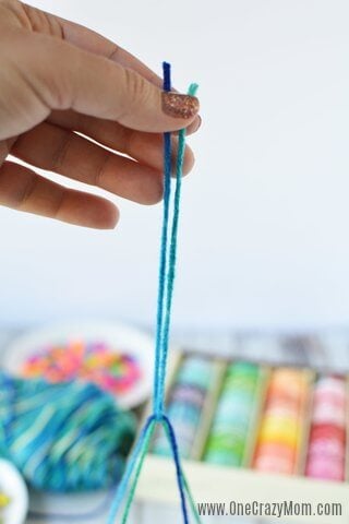 DIY wind chimes are really simple to make. Learn how to make wind chimes. It's so simple and easy. Everyone will have a blast making these pretty wind chimes. String being secured.