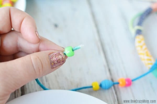 DIY wind chimes are really simple to make. Learn how to make wind chimes. It's so simple and easy. Everyone will have a blast making these pretty wind chimes. Stringing beads on thread.