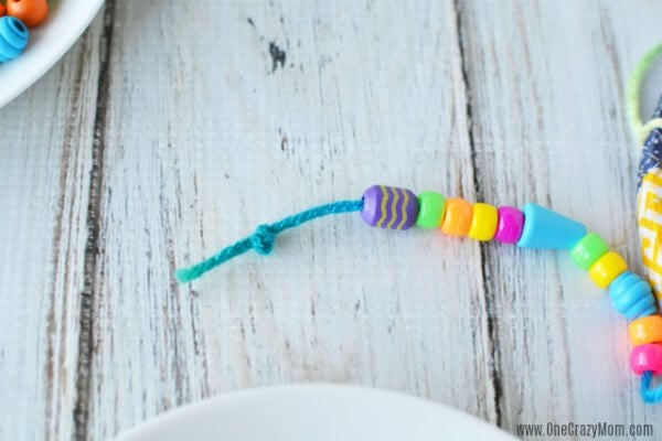 DIY wind chimes are really simple to make. Learn how to make wind chimes. It's so simple and easy. Everyone will have a blast making these pretty wind chimes. Stringing beads on thread.