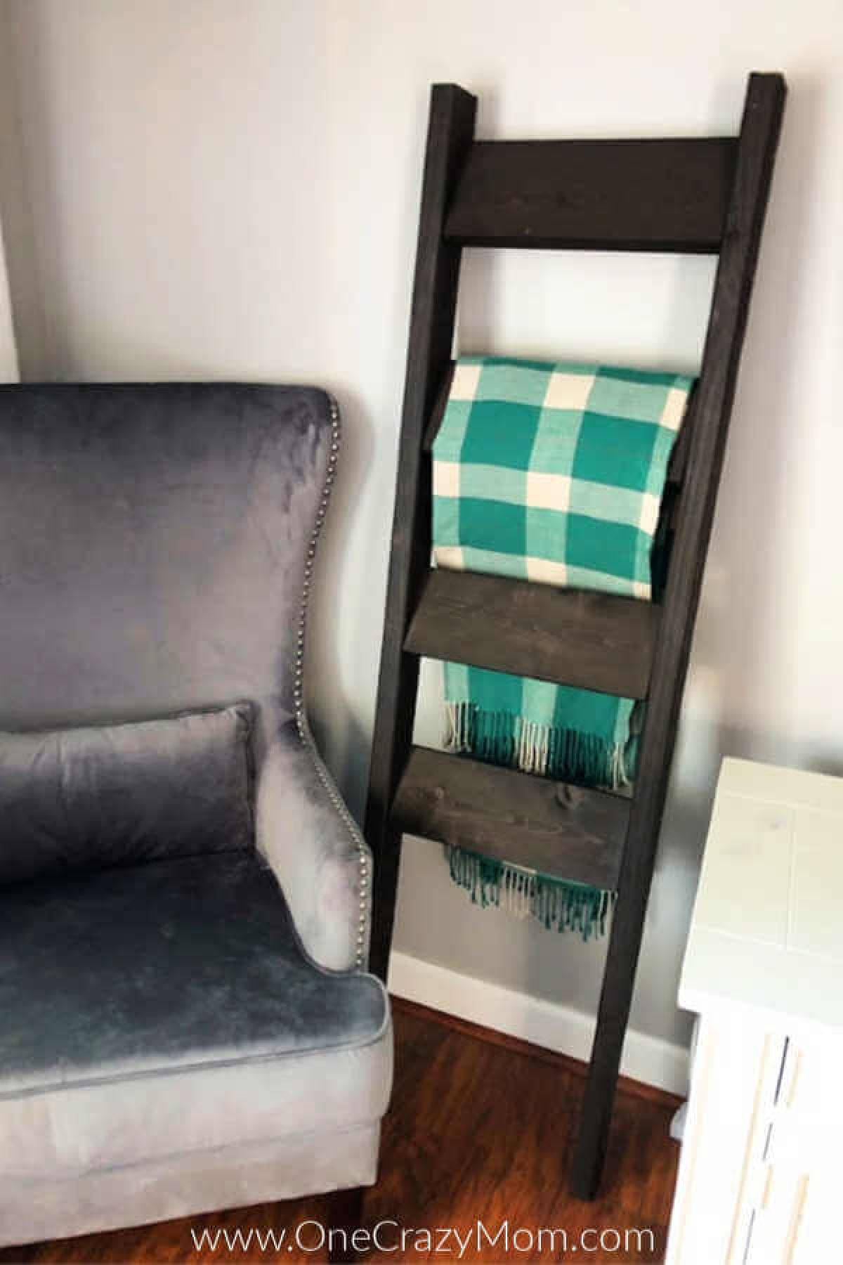 Learn how to make a DIY Blanket Ladder for a fraction of the cost of store bought. This blanket ladder DIY is super easy and so pretty. Blanket ladder against a wall with throw blankets.