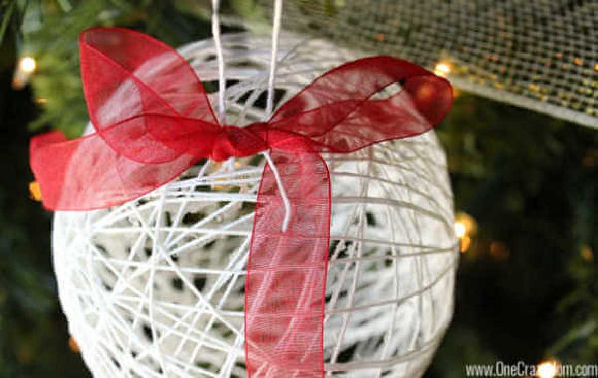 Learn how to make a string ornament for kids. It is so easy to make DIY Christmas Ornaments and budget friendly when all the supplies are from the Dollar Store! #onecrazymom #DIYornaments #christmasornaments