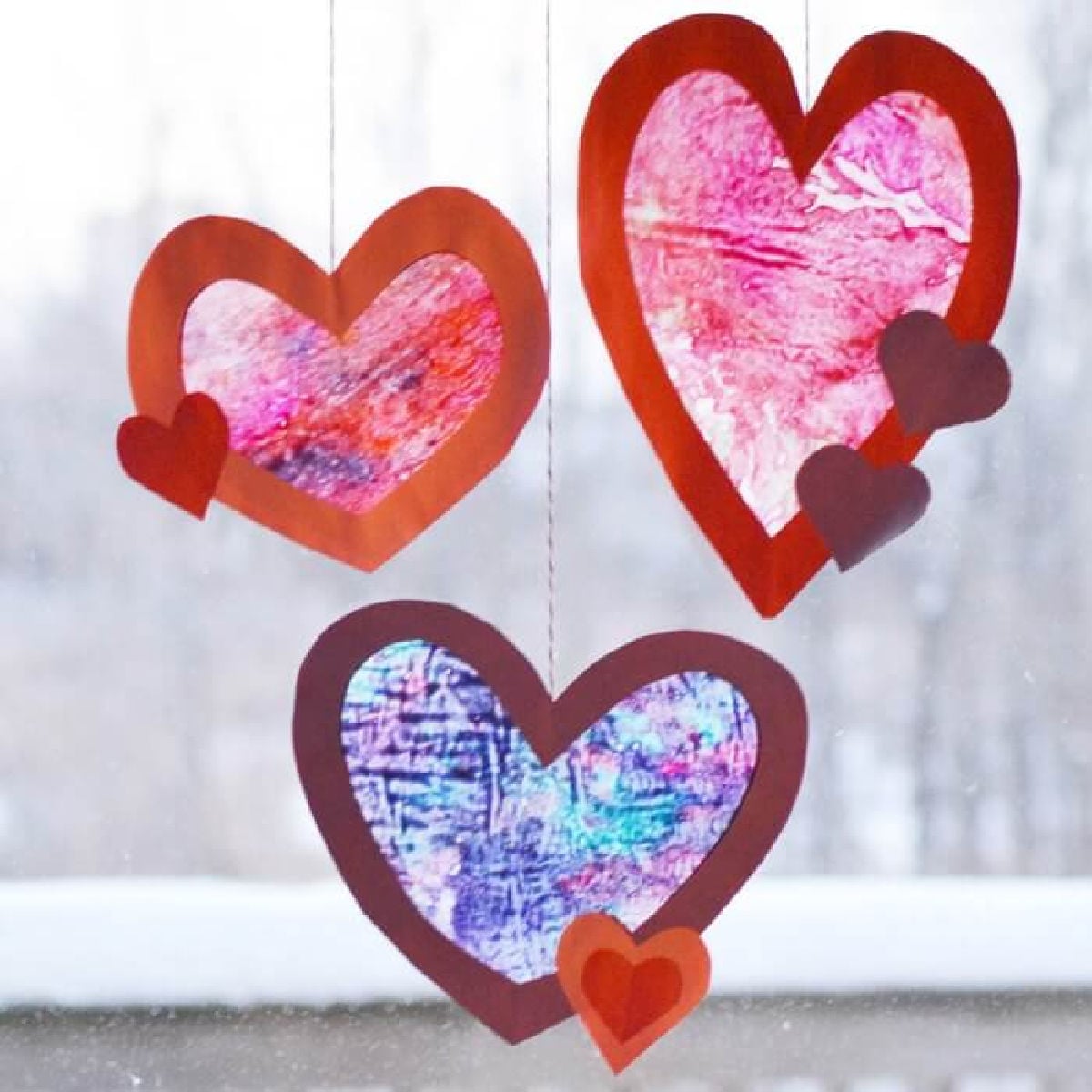Let the kids make homemade suncatchers for the perfect Valentine's Day Craft. They will love this heart suncatcher and it's so simple to make. Let the kids make homemade suncatchers for the perfect Valentine's Day Craft. They will love this heart suncatcher and it's so simple to make.