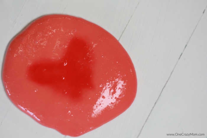 Learn how to make color changing slime and impress your kids. If they are crazy over slime, they are going to love making this color changing slime recipe. Slime on table.