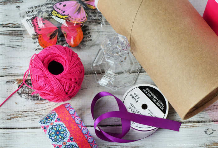 Make this easy DIY Headband Holder and organize your hair accessories. You probably already have what you need to make this adorable DIY Headband Holder. Supplies needed for project - oatmeal container, fabric tape, ribbon, glue, butterflies, candlestick.
