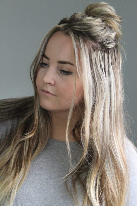 We have over 15 half up half down hairstyles that anyone can do including busy moms. These styles are easy to do and look put together and polished. Messy bun in hair.