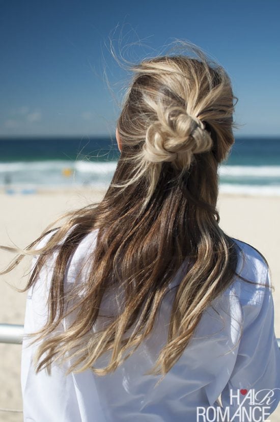 We have over 15 half up half down hairstyles that anyone can do including busy moms. These styles are easy to do and look put together and polished. Half top knot in hair.