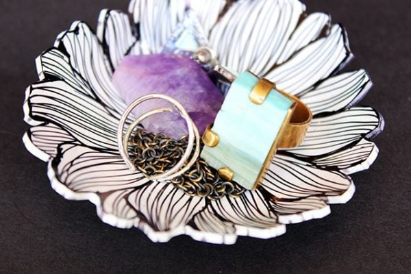 Everyone will have a blast making these 25 Shrinky Dink ideas that are easy to make. Find ideas from key chains and necklaces to magnets and much more! Ring bowl with jewelry.