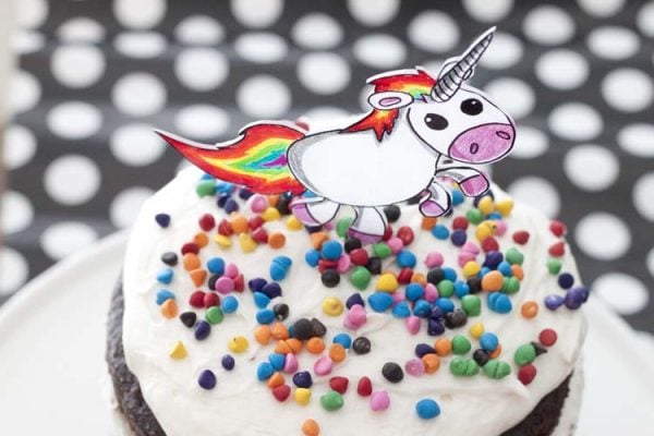Everyone will have a blast making these 25 Shrinky Dink ideas that are easy to make. Find ideas from key chains and necklaces to magnets and much more! Unicorn Cake topper on a cake.