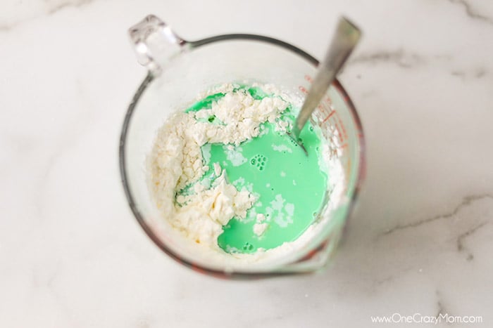 If your kids like to make slime, they will enjoy learning how to make oobleck. You only need 2 ingredients and this DIY doubles as a science experiment. Measuring cup with ingredients ready to mix.