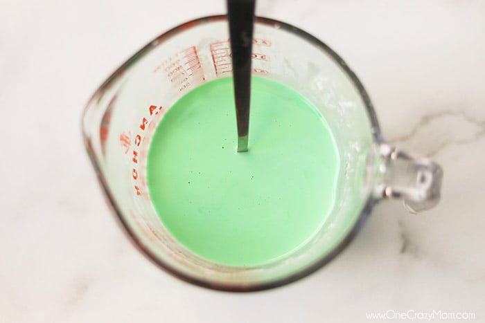 If your kids like to make slime, they will enjoy learning how to make oobleck. You only need 2 ingredients and this DIY doubles as a science experiment. Measuring cup with ingredients mixed with a spoon.