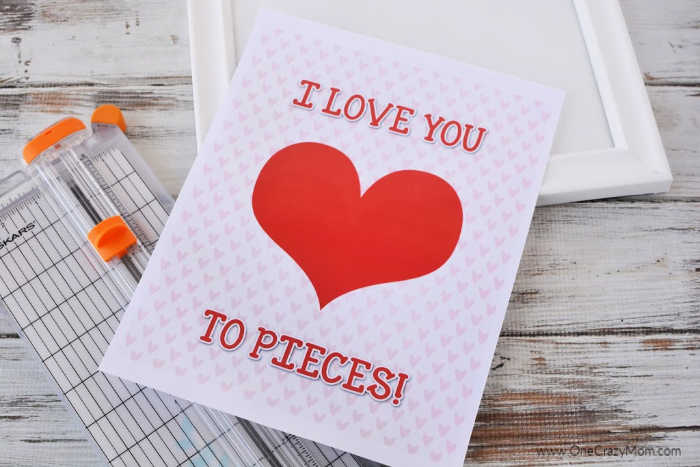Valentine's Day is around the corner and you are going to have a blast making this I love you to pieces craft. Get your free i love you to pieces template. Supplies needed for Love you to pieces craft - template, scissors, frame, puzzle, tape, white spray paint, red spray paint, hot glue and hot glue gun.