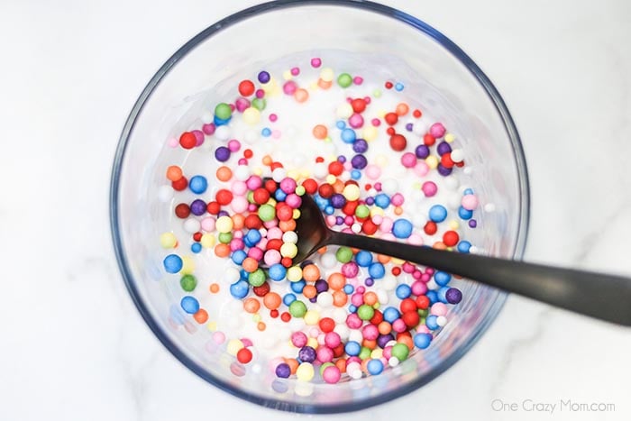 Learn how to make Birthday Cake Slime with only 3 ingredients. Adults and kids love making this birthday cake foam slime recipe in just minutes. It's easy to make this DIY slime recipe! #onecrazymom #slimerecipes #birthdaycakeslime Beads added to starch and ready to blend.