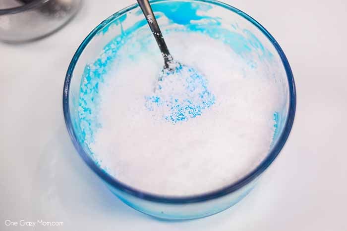 We have the best cloud slime recipe and it is super easy to make. If your kids love slime, they are going to love to learn how to make cloud slime. Instant snow being mixed into slime.