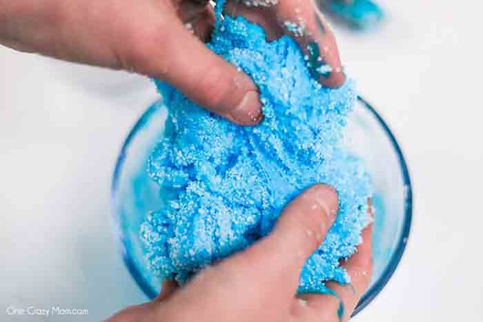 We have the best cloud slime recipe and it is super easy to make. If your kids love slime, they are going to love to learn how to make cloud slime. Hands mixing slime together.