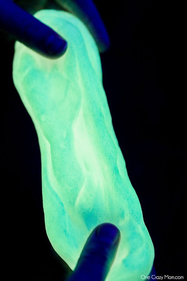 Glow in the dark slime in hands.