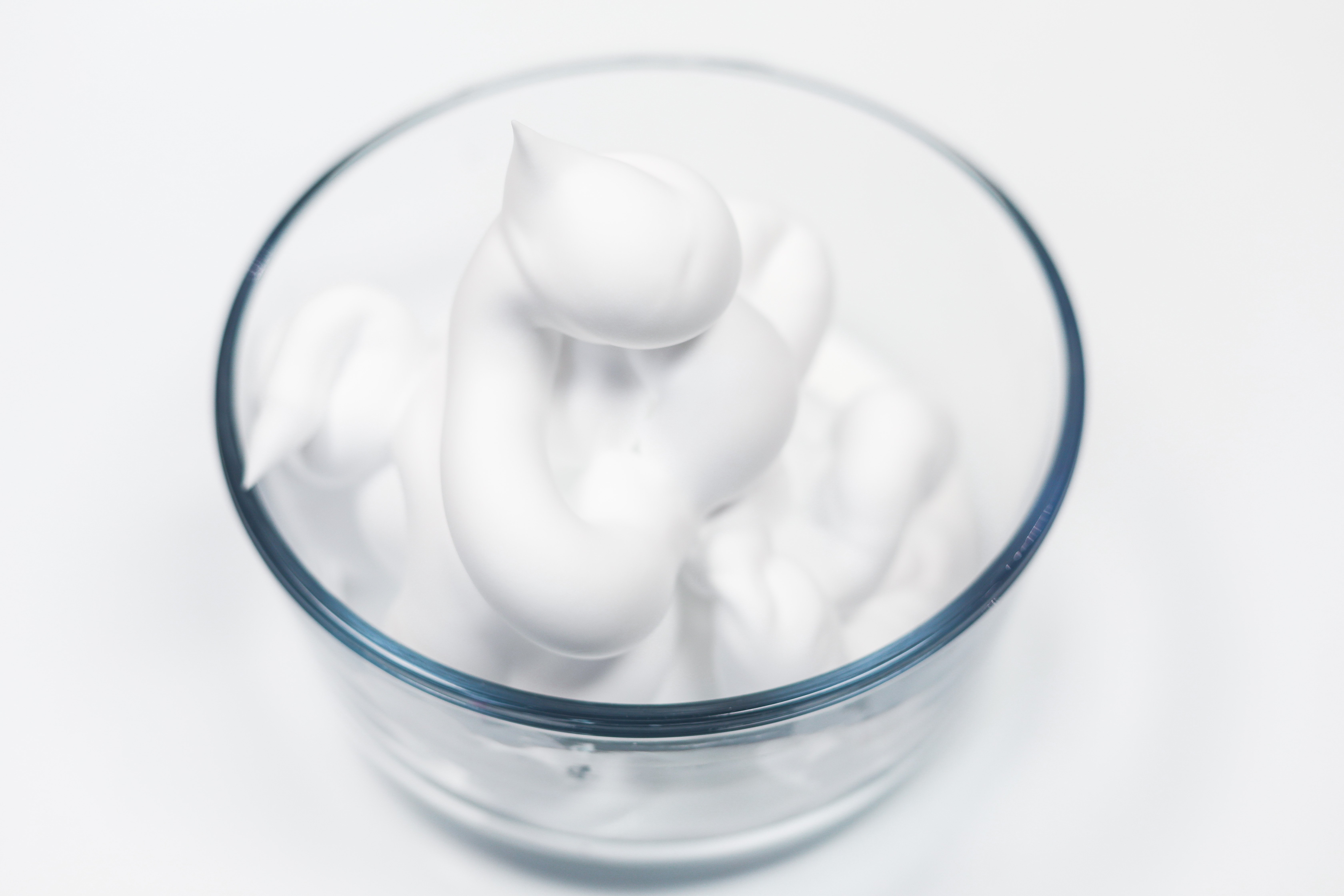 Snow Slime is so fun to make and only requires a few supplies. This is super easy and the kids will go crazy over this snow slime recipe. Shaving cream in bowl.