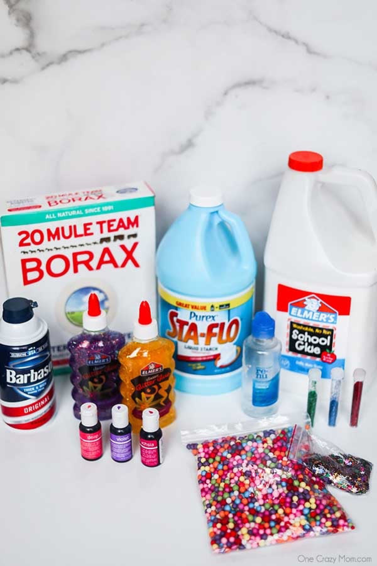 Find out the best slime supplies needed to start fun slime experiments including the best place to get slime supplies and cheap slime supplies! You’ll love this slime supplies list including items that can be found at the dollar store. If your kids love slime, you’ll want to review this supplies list today! #onecrazymom #slimesupplies #slime Slime supplies arranged together -borax, sta-flo, glue, shaving cream, food coloring, glitter glue, contact solution, confetti.