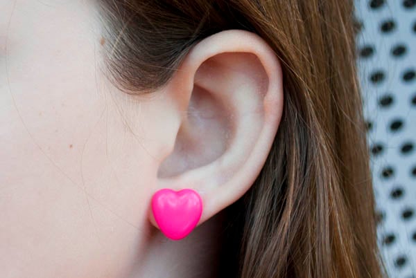 Perler bead crafts are so much fun and we have over 15 easy perler bead ideas. Choose from picture frames, magnets and so much more. Pink heart earrings on ear.