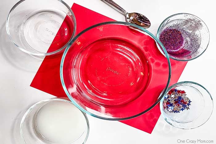 Our kids are crazy over slime and this 4th of July Slime diy is full of all things red, white and blue. Try this patriotic slime for a fun activity. Ingredients for patriotic slime - glue, water, starch, glitter and confetti.